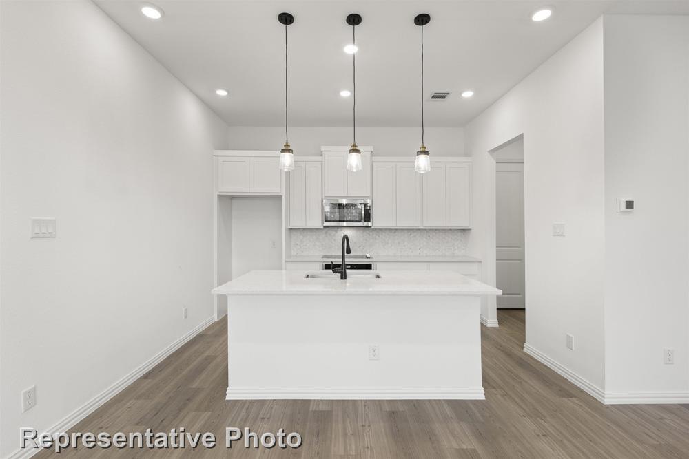 MLS# 20455938 - Built by Ashton Woods Homes - Ready Now! ~ Beautiful new home 7 miles from downtown Dallas with easy access to US-75, US-45, I-30, I-35E, US-80, trendy restaurants, boutique shopping, museums, and entertainment. This 2-story home plan is the Hudson design  and features a kingsize ACME brick and natural stone exterior, a covered front porch, and an 8ft front door. Entertain family and friends from the premium kitchen designed with an eat-in bar top island, Energy Star Whirlpool stainless steel appliances, dishwasher, LED lighting, a built-in microwave and oven, ceramic tile backsplash, Moen faucet, undermount stainless steel single bowl sink, 42-inch shaker cabinets, a pull-out waste basket, pendant lighting, solid surface quartz countertops, and a storage pantry.  Also includes LED disc lighting, energy efficient dual pane windows, Moen faucets,  door hardware, a Ring doorbell, smart home system, ceiling fans, new home warranty.
