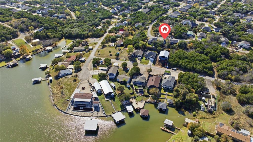 *MOTIVATED SELLER*Your dream lake-house retreat awaits on highly desired Lake Granbury. Welcome to 2707 Austin Dr, a beautifully updated A-frame home tucked inside the secure gated community of Canyon Creek. Filled with warmth, character and natural light, this home blends modern style with the cozy feel of classic lake living.
This charming 2 bedroom, 2 bath floor plan also features an upstairs bonus room that easily functions as a 3rd bedroom, game room or guest suite. The open living space showcases tasteful finishes and soft, inviting colors, creating a peaceful atmosphere from the moment you step inside. The adorable lake-inspired kitchen features an island, stainless steel appliances and everything needed to make hosting effortless — and the refrigerator conveys.
Take in the breathtaking lake views from the private upstairs balcony, sip coffee on the welcoming covered front porch, or bring your boat and toys — the oversized driveway provides plenty of room for parking and storage.
This home has been thoughtfully updated with fresh interior and exterior paint, laminate and tile flooring and modern fixtures, making it move-in ready for full-time living or weekend escapes.
Located in one of Granbury’s most loved gated communities, Canyon Creek offers true resort-style amenities including:
big pool and small pool, basketball court, tennis courts, multiple parks and playgrounds, community fishing dock and boat docks, ramps and clubhouse and 24-7 gated security.
Residents rave about the peaceful setting, wonderful neighbors and relaxed lifestyle.
Whether you're looking for a serene full-time residence, a lock-and-leave weekend getaway or an affordable lake-house investment, this home delivers the Granbury lifestyle so many dream of and rarely find at this price point. Come experience it for yourself and see why everyone loves Granbury.