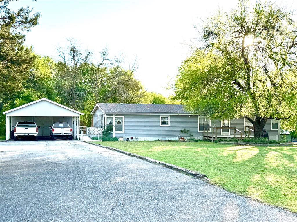 Welcome to your lake life dream nestled in the serene Quail Creek community of Pottsboro, Texas near Lake Texoma! This charming 3-bedroom, 2-bathroom home delivers everything you need for waterside living without breaking the bank.

Step inside to discover a roomy kitchen and living area perfectly designed for family gatherings, holiday feasts, and those lazy Sunday mornings with coffee in hand. The generous primary bedroom features an attached ensuite, offering a private retreat after long days on the water. Thoughtful accessibility features include an entry ramp and a handicap accessible primary shower, ensuring everyone feels welcome. A dedicated laundry room rounds out the interior conveniences.

Now, let's talk about the outdoor magic. A spacious covered deck beckons you to relax, grill, and soak in the peaceful surroundings. The large lot provides breathing room that most lake properties simply cannot match, with ample parking space and paved roads leading right to your paved driveway. Got a boat, camper, or weekend toys? The property includes a recreational vehicle hookup and a detached enclosed storage ideal for your golf cart and other lake essentials.

Location is where this gem truly shines. Highport Marina sits just about a mile away, putting you moments from open water adventures. Grab brunch at Schooner's Breakfast and Brunch or unwind with drinks and a sunset at The Island Bar and Grill — all practically in your backyard.

Affordable lake living with this much character does not come around often. This is truly one of those properties you just need to see to appreciate. Schedule your showing today!
