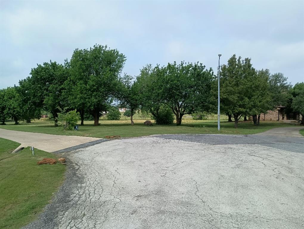 Build your dream home nestled in a quiet cul-de-sac with amazing views to the neighboring countryside. This 1.3 acre lot gives you plenty of space to roam and privacy. This is a perfect location for those wanting tranquility, yet, remaining close to all the town amenities. Come check out the established neighborhood with oversized lots, friendly folks, and gorgeous surrounding homes. 

This is one of the last and larger lots available in the development. Don't wait as this lot will not last long. No HOA! No HOA! No HOA!

YES! Fiber internet from Nortex is available. City water and sewage is all at the street. No mobile homes. Minimal architectural restrictions. Single family residential use only. No subdividing. Home must be at least 2,000 sq. ft. Exterior walls must be at least 75% brick veneer, masonry, or similar material. See restrictive covenants.