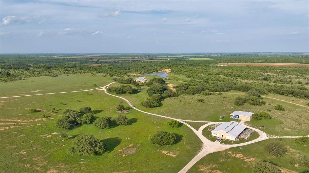 The 392 acre CM Ranch is a turnkey, full scale Texas ranch built for both enjoyment and day to day operation, featuring a premier main home, strong water, quality horse and cattle infrastructure, and a layout that works. With multiple pastures, productive ground, and a large lake setting, this property delivers a rare blend of comfort, function, and long term value in one complete package.
The centerpiece is a two story rock home set high with sweeping views across the ranch and the lake. Built in 2002, the home is approximately 6,000 square feet per owner and features 5 bedrooms and 5.5 bathrooms. The garage enters into an oversized mud room and laundry room, the main living area is anchored by a rock fireplace and expansive windows, and upstairs includes 3 bedrooms, a game room, a media room, and a balcony. The home is supported by three newer air conditioning units.
Horse facilities include a barn with 8 stalls with water and a hay loft, plus a foreman’s suite inside the horse barn with a full kitchen and full bathroom. Water is a standout feature with five tanks total, including a larger tank lake that can be approximately 20 feet deep when full and roughly 8 to 10 acres at capacity. The ranch is divided into 8 pastures and offers excellent wildlife habitat. The owner reports strong deer activity when wheat is up, along with turkey, quail, and other native game, and the property has not been hunted in approximately 15 years.
For cattle and crops, approximately 75 acres have been planted in wheat, canola, and Sudan for hay, and the ranch currently runs about 25 head for casual ranching. Additional improvements include an equipment barn and multiple water taps throughout the property. Utilities include county water, Coleman County Electric, a 250 gallon propane tank for the kitchen stove via West Texas Gas, internet currently via Starlink with county service wired to the house and barn, and a 500 gallon diesel tank on stilts at the barn.