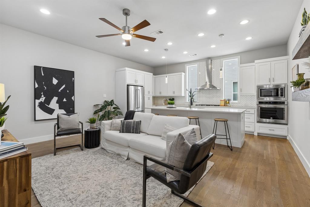 Experience contemporary urban living in this stylish three-story townhome in the gated Urban Place community, ideally located just minutes from Lowest Greenville, Deep Ellum, Uptown, and Downtown Dallas. With clean lines, soaring ceilings, abundant natural light, and an open-concept design, this home offers the perfect blend of sophistication and functionality. The first floor features a private guest bedroom with an ensuite bath, a convenient laundry area, two-car garage, and a gated front yard space. The main living level is filled with natural light and features 10 ft ceilings, hardwood floors, and an open-concept layout designed for effortless entertaining. Anchored by a stunning, oversized quartz island, the kitchen features KitchenAid stainless appliances, a gas cooktop and extensive cabinetry. 
Retreat to the quiet and spacious primary suite, also on the 2nd level. that includes a oversized shower with modern finishes. The top floor offers a flexible bonus room ideal for a home office or fitness area and opens to your own private rooftop terrace. This exceptional outdoor living space is perfect for morning yoga, sunset cocktails, or entertaining friends under the city lights.
Energy efficient features include a tankless water heater, smart home wiring, and the security and convenience of gated community living in one of Dallas' most desirable central locations. This is an ideal fit for someone who wants quick access to downtown while still enjoying a quieter neighborhood feel.