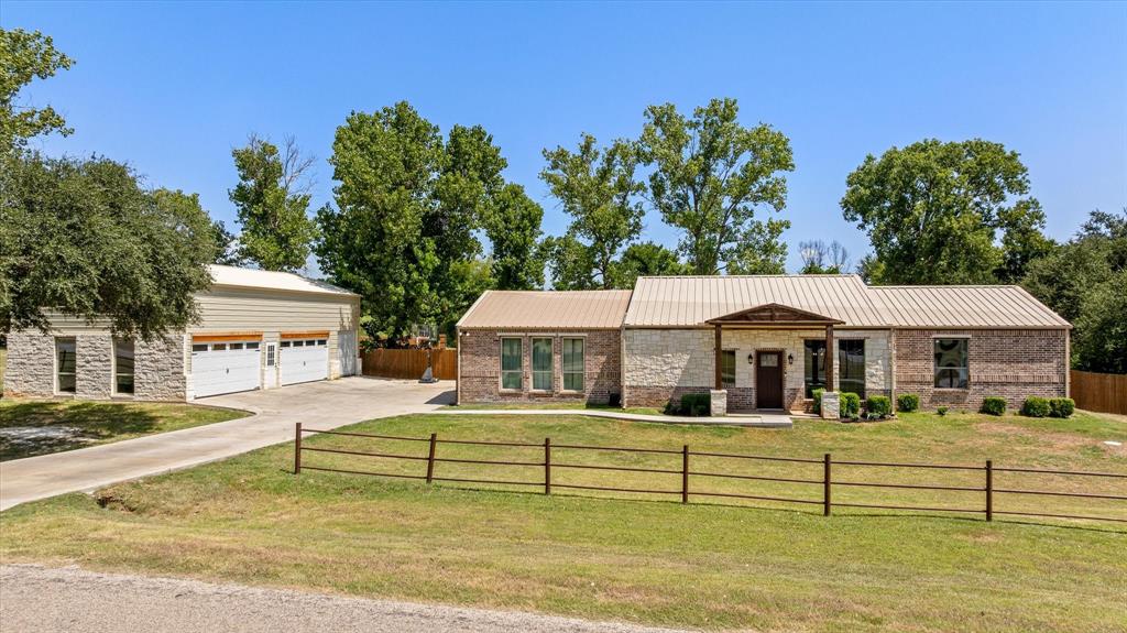 WANNA POOL FOR SUMMER TIME FUN?? THIS HOME HAS ONE!! Nestled on 3+ beautiful acres on the highly desirable Fort Worth side of Granbury, this stunning 3 bedroom, 2 bath home offers the perfect combination of country living and everyday convenience. Located outside the city limits, you’ll enjoy privacy, wide-open spaces, and fewer restrictions while still being just minutes from schools, shopping, dining & entertainment. HEB & Kroger are only 5 minutes away! Serene setting, mature trees & an inviting atmosphere is what this property offers. Spacious open-concept kitchen & dining area. Huge living area that serves as the true heart of the home, perfect for hosting holidays, game nights & unforgettable gatherings with family & friends. Step outside and experience the backyard oasis! The oversized covered patio with TV hookups creates the ultimate outdoor entertaining space, while the sparkling saltwater pool is ready for endless SUMMER FUN! Whether sipping your morning coffee while listening to the birds or enjoying evenings under the Texas stars, this outdoor space is designed for relaxation and making memories. Need EXTRA space for vehicles, toys, hobbies, or a workshop? The impressive 5-car detached garage is a rare find and includes an upstairs storage area, giving you endless possibilities for storage, projects, or additional workspace. An exterior 50-amp outlet adds even more flexibility for RV parking or future needs. Adventure lovers will appreciate a go-cart path winding past the tree-lined area, perfect for weekend fun right on your own property. With plenty of room to roam, entertain & truly enjoy the outdoors, this property offers the lifestyle so many buyers are searching for but rarely find. Imagine hosting backyard BBQ's, parking all your toys with ease, or simply escaping the hustle and bustle of the city without sacrificing convenience.