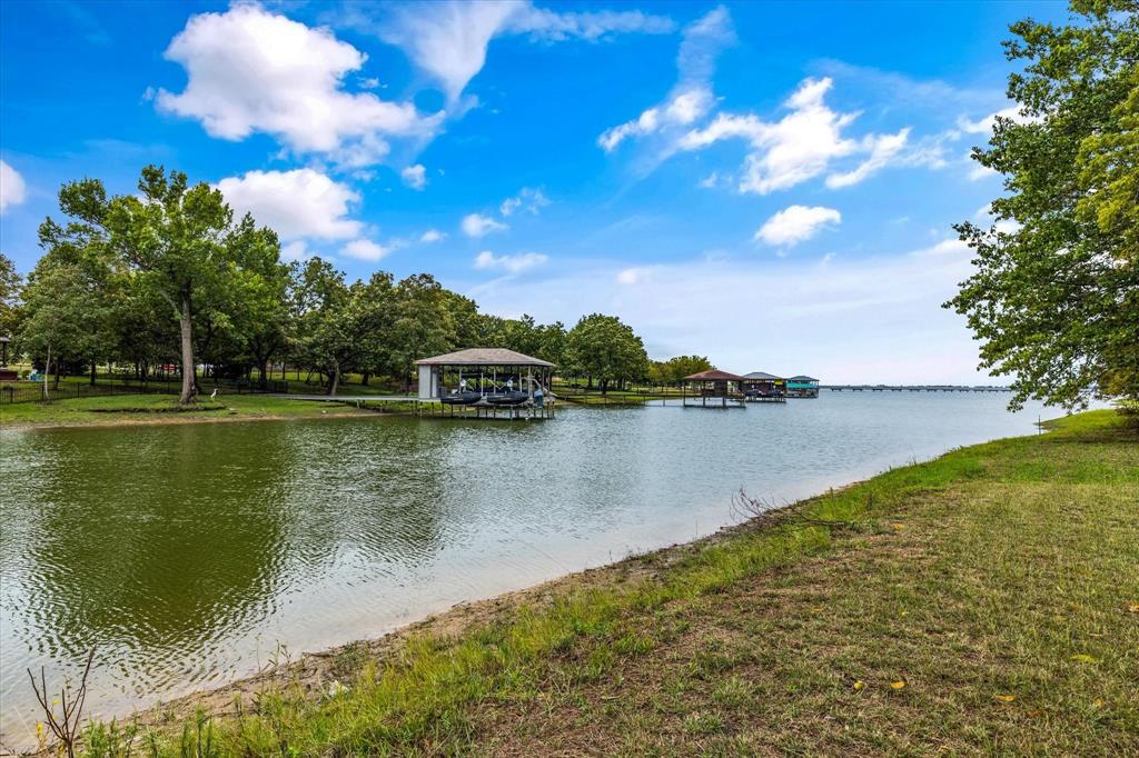 Embrace the charm of lakeside living in our prestigious gated community, where this spacious lot is situated just steps away from the tranquil waters of the lake. Nestled in the heart of nature, this prime location offers you the unique opportunity to enjoy all the recreational and natural wonders the lake has to offer. With the soothing sounds of water nearby and the community's secure surroundings, you can craft your ideal retreat. Don't miss out on the chance to call this exceptional lakeside community your home.