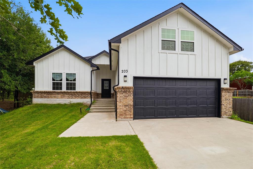 This stunning 2022 modern farmhouse in Keene ISD commands attention from the moment you arrive. Framed by many mature trees, the home offers a sense of privacy and presence that is hard to find in a neighborhood setting. Step inside to an open concept layout with vaulted ceilings, exposed beam detail, and rich dark hardwood style flooring that flows seamlessly through the main living areas. The kitchen is equipped with a large island, quartz countertops, white shaker cabinetry, gray subway tile backsplash, and stainless appliances. The primary suite is a true retreat with a spa worthy bathroom featuring marble look tile, a frameless glass shower, soaking tub, dual vanities, and designer black hardware throughout. With five bedrooms including a spacious pop up upstairs bonus room, this home has the space and style to fit every lifestyle. Attached two-car garage features a convenient pass-through grocery door for easy unloading directly into the home. Elisa Park is just a short walk away, offering a park, baseball fields, walking trails, and open green space perfect for an active lifestyle. Southwestern Adventist University is also nearby, adding a close-knit community feel that makes Keene truly one of a kind.