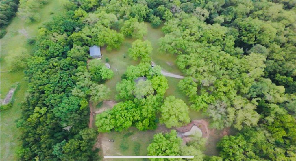 Escape to Tranquility, Just Minutes from the City!

Nestled on 20 stunning acres of wooded land, this charming home offers a serene retreat with easy access to the city. The property boasts a seasonal pond, over 160 mature pecan trees, and a variety of oaks, walnuts, and other beautiful timber, creating a picturesque landscape year-round.

A private gate leads you down a scenic .3-mile drive, crossing a charming bridge over Walnut Creek. The setting is nothing short of breathtaking. With a spacious 30x40 (2) stall barn that’s fully powered and a stylish greenhouse adding to the charm, this farm-ranch-inspired property is full of potential.

Currently holding an ag exemption, this unique estate is just 3.5 miles from historic downtown Mansfield, close to Mansfield Methodist Hospital, shopping, dining, and more. Located in an unincorporated area, this property offers incredible long-term investment potential. Whether you're interested in farming, recreation, or simply a secluded country lifestyle, the possibilities are endless.

The cozy cottage, nestled among the trees, is move-in ready and offers the perfect blend of privacy and outdoor beauty. Whether you're an executive, entrepreneur, or someone seeking a peaceful rural retreat, this property is ideal.

Mansfield real estate is in high demand, so come see what all the buzz is about. Recent updates include a new roof (2024), new HVAC system (2023), and new flooring in the lower level (2024) with the upper level completed in 2025.

Schedule a visit today – this one won’t last long!

*** Mobile homes are prohibited. Buyers and buyers agents to verify all information contained herein.