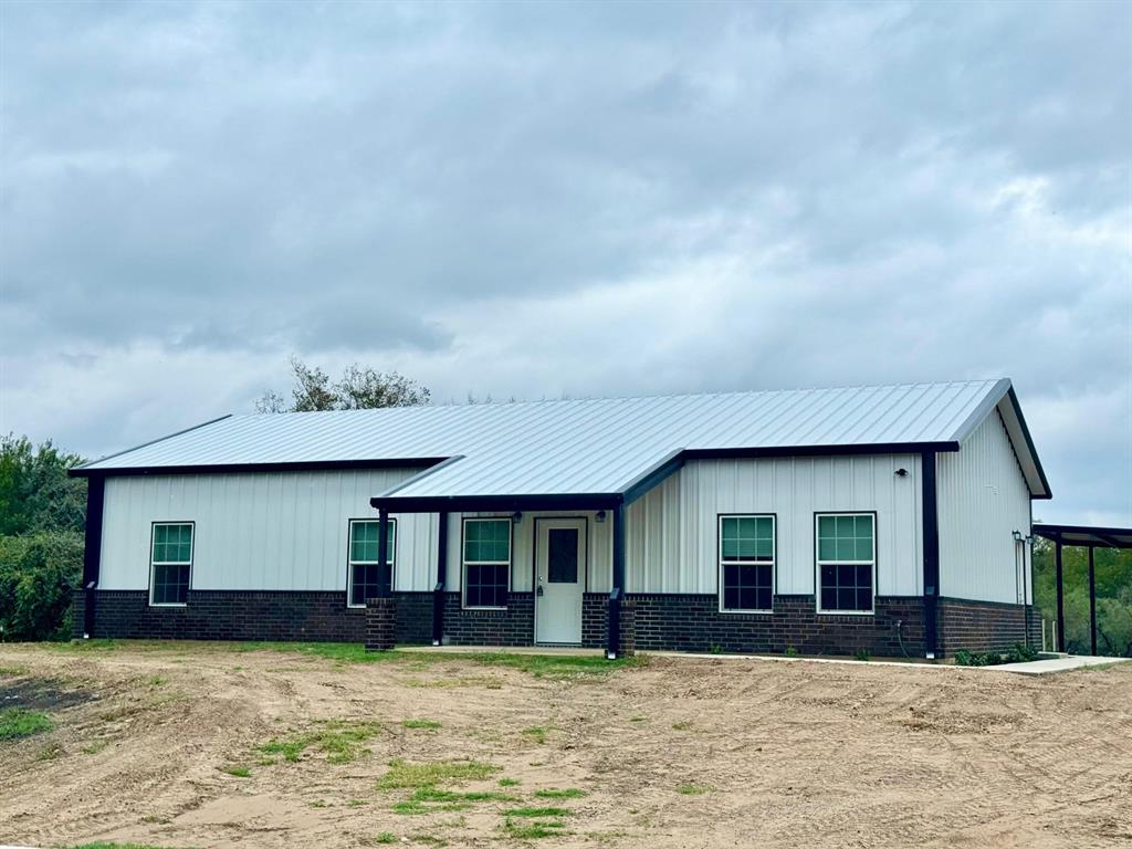Price Reduced!  Just completed new construction! Brand new 3 bedroom, 2 bath barndo on almost 1 acre.  Springtown school district.  Carport for 2 vehicles.