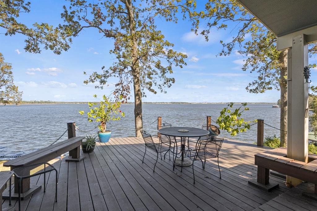 Breathtaking view from this hilltop property on beautiful Lake Bob Sandlin!  If you want the best view and the best water, this is it!  20 ft deep at the boathouse!  Located on a gorgeous cul-de-sac in Thunderbird Point, surrounded by million dollar homes, you don't want to miss this one! This beautiful double wide mobile home that has been retrofitted and has 3 bedrooms, 2 baths, with a large sunroom with windows all around for a great view of the lake!  It has a gas fireplace, new, life-time, luxury vinyl plank flooring, new roof, awesome boat house, 2 car garage, separate utility garage with a side carport.  The lake side of the property is terraced with stone walkways leading down to each landing.  This would be a great weekender, VRBO or a wonderful full time residence!  Call today for your private showing!