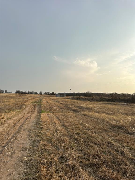 Enjoy your country escape from the moment you arrive. There is a green pipe gate, 1,800 foot drive way and 170 foot water well already in place! You won't find this price anywhere with all these amenities ready to go! 30x60 workshop with 200 amp electric, two doors, one at 10 foot and the other 12 foot, plumbed for water and a 19x30 overhang. A well maintained pond is shared with the neighboring property to the west. Property lines are marked with green metal posts. There is a document attached that lists all the items being left with the property including a nice tractor. 
There are 2 electric meters, one for the well and one for the shop.
This is ready for your new home, or you could turn the workshop into your home as well.
Several items in the shop will go with the property, Tractor, brush hog, and implements, and compressor.