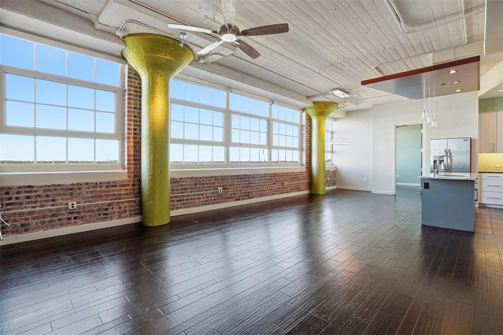 Expansive Windows and Views are great in this Beautiful 2 bedroom, 2.5 bath condo on the 5th floor of the East Tower at Montgomery Plaza. This spacious unit features an open layout, high ceilings, and approximately 65 ft of historic windows providing abundant natural light and views of the surrounding shopping, dining, and business district. The kitchen includes granite counters, stainless appliances, and an island open to the living area. Both bedrooms offer en-suite baths and generous closets, plus a guest half bath.  A large office or expanded living area is precisely designed to open to the living areas. The living area features two original Art Deco style columns along the window wall.  Located at the end of the hallway, the entrance is stunning! Large bathrooms each feature a separate shower, and large walk in closets. A large utility room is a plus with a sink and plenty of storage area!  Two large deeded parking spaces included. Residents enjoy resort-style amenities: rooftop pool deck, fitness center, theatre room, 24 hr concierge, and secure fob access entry. Conveniently located in the heart of West 7th with excellent walkability to dining, shopping and entertainment!  Quick access to the Trinity River Trails. Montgomery Plaza, built in 1928 in Mission Revival style with Art Deco details, is now a thriving community of luxury loft condos offering premier urban living in Fort Worth in the Cultural District. Walkability score is 77.  Biking score is 79.  Make this condo your City Home... you will LOVE it!