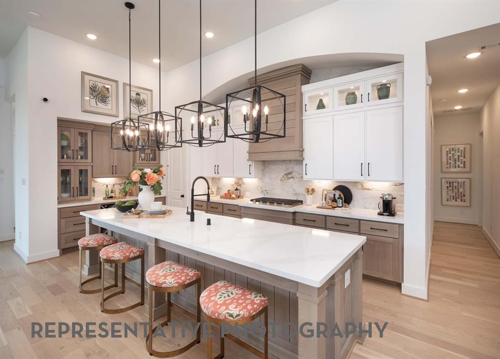 Plan 215 Is one of Highland Homes most popular one story floor plans.  4 BR, media, study and dedicated dining.  This home revolves around the kitchen with an almost 10' center island.