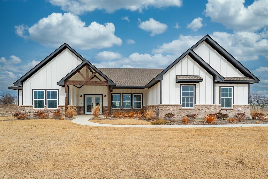 This custom four bedroom, two and a half bath home has all the bells and whistles on 1 acre! As you walk into the front entry, you'll immediately notice the high ceilings, custom light fixtures and luxury vinyl plank flooring throughout. Perfect for those with allergies, this home has no carpet! Features include a lovely dining area, spacious living room with fireplace and custom built-ins, plus a gourmet kitchen with an abundance of cabinetry, high end quartz countertops, stainless steel appliances and a beautiful picture window overlooking the backyard. The primary suite is a private oasis separated from the other bedrooms and has a spa-like bath with luxurious walk-in shower, beautiful tile work, dual sinks and walk-in closet. Secondary bedrooms are all nicely sized. Watch the Texas sunrises & sunsets from the 2 porches! Fence negotiable.