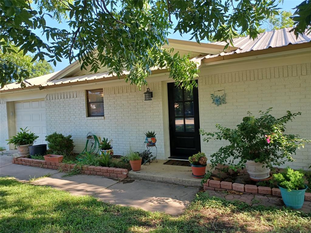 No work here, just move in and enjoy your new home. Shaded in front from the west sun with large pecan trees, this home is also protected by a metal roof. Recent paint and wood work outside along with a new garage Overhead door and opener with a convenient keypad outside. Very large kitchen with plenty of cabinets, updated lighting, granite counter tops, aluminum farm sink and bronze faucet with sprayer. Easy access to the garage to bring in the groceries. Bathroom was updated with lighting, mirror, and vanity with matching granite counter top. Both bedrooms have two closets for abundant storage. For more storage, see the 15x9 metal building in the backyard. It is on Concrete and very sturdy. The covered patio just needs a picnic table to be the perfect place to hang out with friends. This neighborhood has proven to be one of the best for an evening stroll to wind down from the day. Located near Woodland Heights Elem, Middle School, sports fields and the Camp Bowie Aquatic Center.