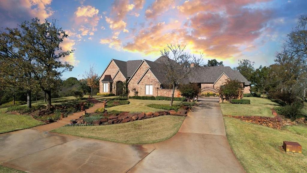 Welcome to 811 Russell Lane, your private escape nestled on 26+ acres of picturesque pastureland. This striking massive custom-built home offers the perfect blend of comfort and luxury. Perfect for both entertaining and peaceful living, this home is an architectural masterpiece, showcasing its custom design, high-end features, and impressive wood craftsmanship throughout. As you enter the home, the grand entry hall welcomes you with its 22-ft ceilings, bright natural light, formal parlor, dining room, and library-study with intricate oriental wood panels and shutters. The heart of the home is the great room with open concept kitchen and living area anchored by the oversized stone fireplace. The gourmet chef’s kitchen features top-of-the-line appliances, including a commercial-grade gas range & vent hood, built-in refrigerator, cooling and warming drawers, and an oversized island perfect for large gatherings. The private guest wing includes a cozy home theater with 108 in. screen, and three large bedrooms with full ensuite J&J bathrooms and large walk-in closets in each. Opposite the great room is the primary suite wing, which boasts a marble fireplace, Rocco marble Roman-style bathtub and glass brick walk-in shower with mist sprayers. The primary bath also features separate his & her vanities, water closets, and walk-in closets, one of which doubles as a safe room. Primary wing also features a cozy home office and bright & tranquil sunroom with custom cedar paneling and wet bar. A private mirrored exercise room takes up the entire second floor of the home and is complimented by an adjacent full bathroom with steam shower. Step outside into the resort-style backyard, where the stunning infinity pool appears to blend seamlessly with the horizon. The custom outdoor cabana features a built-in grill and fireplace, providing the perfect space for alfresco dining and relaxation. This estate exceed all expectations. Additional 70+ acres available.