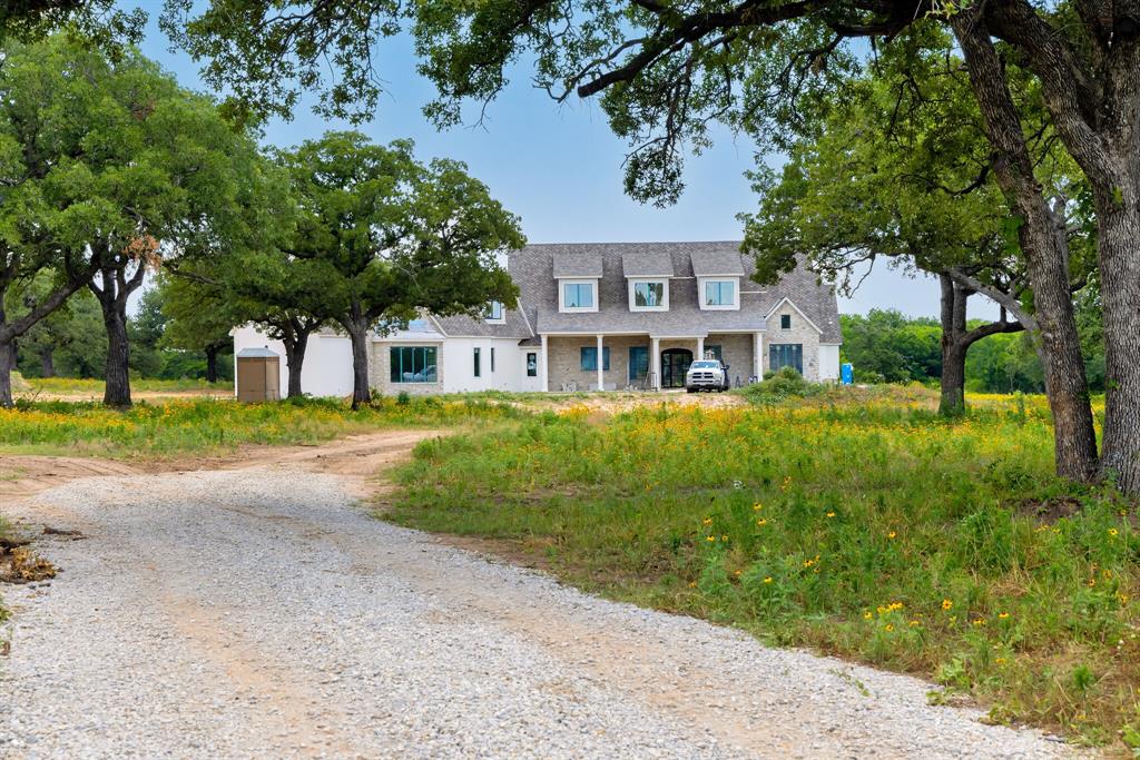 Beautiful property located on perfect place to have your dream ranch. The custom-built home has everything you could ever desire. As you drive up the winding drive to this picturesque country setting and see the magnificent home you be immediately charmed. Upon entering the home, the view of the main living area with tall, vaulted ceilings and beams will stir up excitement to see the remainder of the home. The open concept of living, kitchen and dining offer opportunities to share time with family, and large group gatherings. Kitchen: oversized island, beautiful cabinets, Butler's pantry off kitchen with cabinets, open shelving, built-in China cabinet, and much more. Dining area has coffered ceilings, large utility that is full of cabinets and tons of storage, separate pantry that any chef would envy and much more! Upstairs: large living area, media room, full bath and bedroom and a small kitchen making for convenient entertaining upstairs. Amazing pool and outdoor kitchen too!