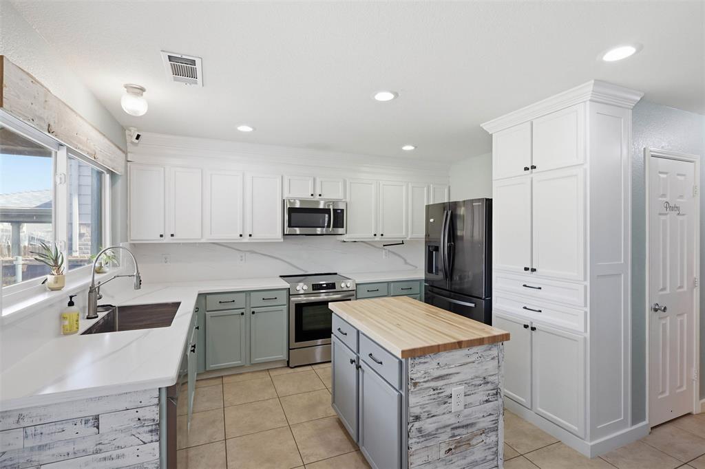 Located in the desirable Ranches community and zoned to Northwest ISD, this well-maintained 4-bedroom, 2.5-bath home offers over 2,500 square feet of comfortable living space. The open floor plan features a spacious family room with a wood-burning fireplace, abundant natural light, and seamless flow into the dining area and updated kitchen. Recent kitchen improvements include upgraded cabinetry, countertops, backsplash, island, and deep sink. Enjoy outdoor living on the extended patio with a covered pergola, lighting, fans, and built-in speakers—perfect for relaxing or entertaining. Energy-efficient upgrades include owned solar panels, an updated HVAC system, triple-pane argon-filled windows on the west side, and new siding installed in 2021. Conveniently located near I-35W, Highway 114, and Highway 170, with easy access to shopping, dining, entertainment, and major employment centers throughout the Alliance corridor. A rare combination of space, updates, efficiency, and location. This home checks all the boxes - come look at it today!!