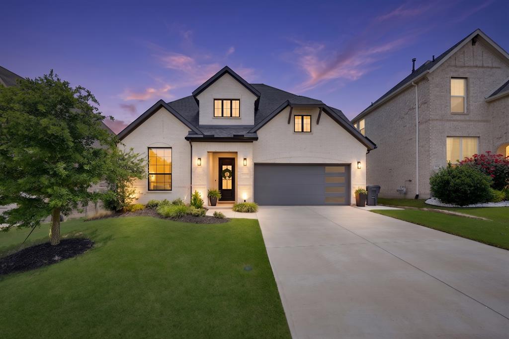 Experience a masterclass in contemporary design with this stunning white-brick custom residence perfectly positioned in North McKinney. From the moment the custom iron entry door swings open, you’re greeted by sprawling, upgraded light wood flooring and an airy upfront study accented by glass French doors and rustic wood beams. The aesthetic is modern and sophisticated, featuring a sleek horizontal stair railing that leads your eye toward a true chef’s sanctuary—a kitchen with stunning quartz countertops and a high-contrast black, white, and gold color palette. In the heart of the home, the family room’s soaring ceilings frame a breathtaking Modern Flames electric fireplace encased in premium quartz. Practicality meets luxury with two of the four bedrooms located on the main level, including a jaw-dropping primary suite boasting a designer-tiled bath and a deep standalone soaking tub. Head upstairs to find a massive, breathable game room and a dedicated media suite featuring custom contemporary lighting. Outdoor living is just as intentional, with a sprawling covered patio equipped with a gas stub, ready for your dream summer kitchen. With 4 spacious bedrooms, 3.5 baths, and access to a premier community pool just minutes from the boutique shops and vibrant dining of Downtown McKinney, this home isn’t just a place to live—it’s a lifestyle upgrade ready for its next chapter. Please see private remarks on how to set up a showing.
