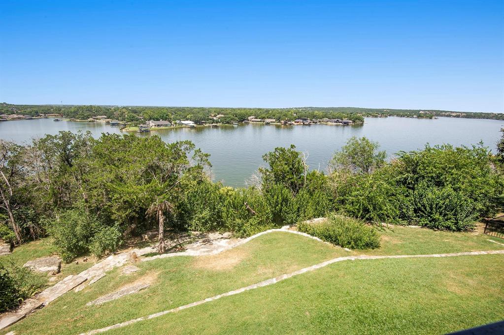 Experience the best of waterfront living on the main body of the lake, with approximately 35 feet of water depth right off your private dock. This exceptional retreat offers 3 spacious bedrooms, 2 full baths, and two inviting living areas designed for both entertaining and everyday comfort.

Enjoy breathtaking lake views from multiple vantage points throughout the home, creating a seamless blend of indoor comfort and outdoor beauty.

Step outside to your private boat slip with an elevated viewing deck—perfect for morning coffee at sunrise or sunset cocktails over the water. Whether you're boating, fishing, or simply unwinding by the lake, this property delivers the ultimate lakeside lifestyle.
This is a rare opportunity to own premier waterfront property—schedule your private showing today.
Property comes fully furnished and is an established STR.
