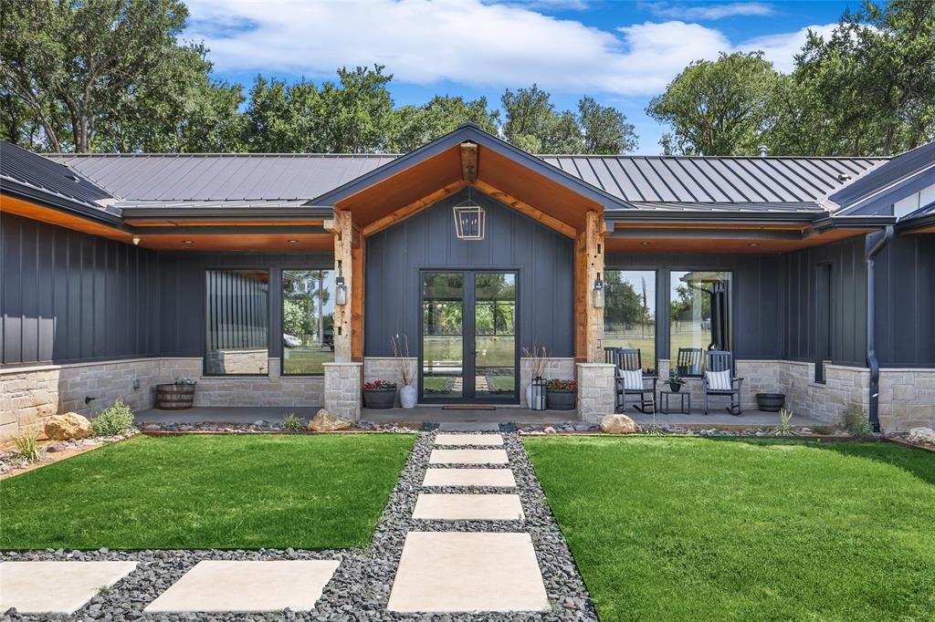 Welcome to your private retreat on over 5.5 acres. As you step into the great room, you're greeted by a stunning wall of windows that bathe the space in natural light, complemented by a cathedral wood-beamed ceiling. The open floor plan seamlessly connects the great room to the built-in breakfast area and chef's kitchen. The primary suite is a luxurious haven, featuring doors that lead to a covered patio, and an en suite that boasts dual vanities, a wet room, and a custom walk-in closet. Entertainment options abound with a media room and a bonus room that offers ample storage space for all your needs. Step outside to the covered living space, where an outdoor kitchen area invites al fresco dining and gatherings. The swimming pool and spa beckon for relaxation. For guests or extended family, the property features separate living quarters. This exceptional property offers a harmonious blend of elegance, comfort, and outdoor allure, providing a lifestyle of tranquility and entertainment.