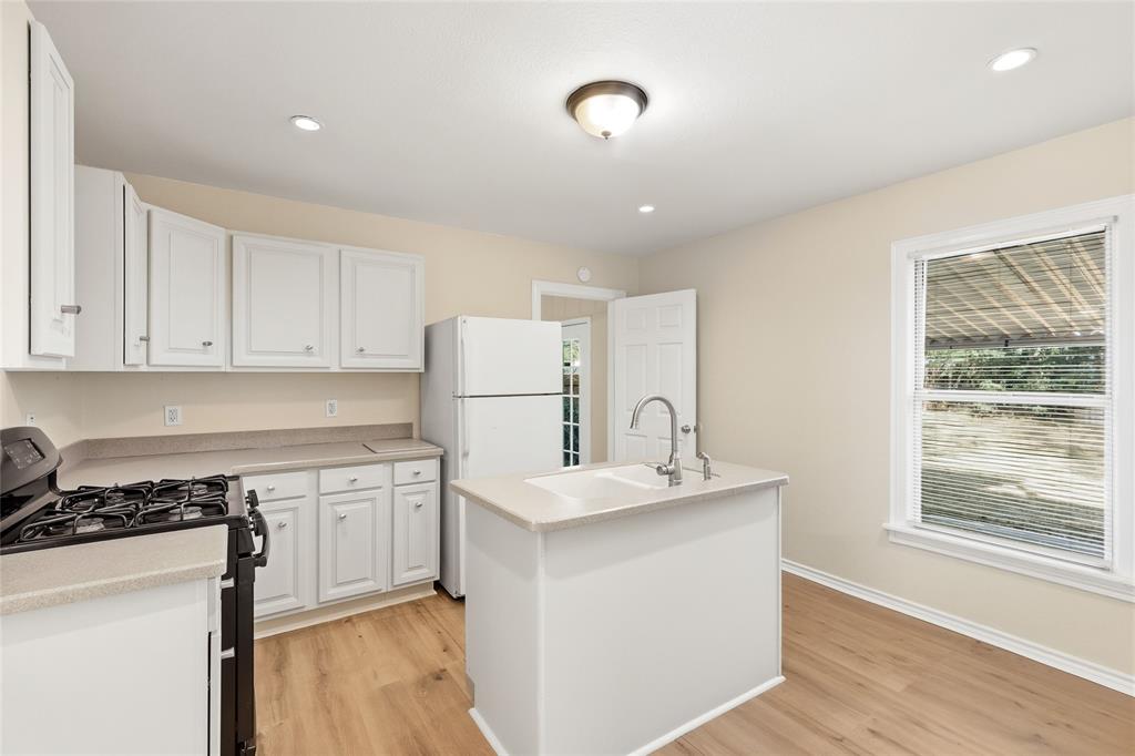 Welcome to this charming and updated 2-bedroom, 1-bathroom home located in the heart of Fort Worth, Texas. This residence boasts a fantastic location, providing convenient access to highways, popular retail shops, and local restaurants. The kitchen is designed for functionality, featuring Corian countertops and a large center island. Throughout the home, you will find beautiful, finished hardwood flooring, 2-inch blinds, and ceiling fans in every room, adding both comfort and classic style. The property also includes a nicely sized utility room. French doors open out to the spacious, fenced backyard with a covered patio, creating an ideal space for outdoor relaxation and entertaining. This home is a must-see!