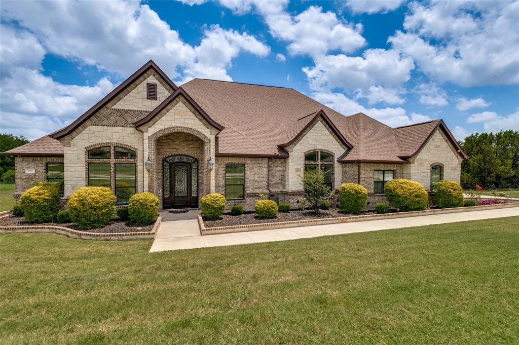 Welcome to this stunning custom-built home nestled in an exclusive gated community, where luxury, comfort, and functionality come together beautifully. Offering 4 spacious bedrooms and 3 full baths, this exceptional property showcases exquisite craftsmanship throughout, including elegant tray ceilings, rich hardwood floors, and thoughtful custom features designed for modern living.

The gourmet kitchen is a chef's dream, featuring a pot filler, double ovens, abundant cabinetry, and plenty of workspace for entertaining or everyday meals. The spacious family room invites you to relax beside the cozy wood-burning fireplace, while the home's prewired sound system enhances your entertainment experience throughout.

The luxurious Hollywood bath offers separate vanities and a large pass-through shower, creating a spa-like retreat. Custom built-in cabinetry within the closets provides exceptional storage without sacrificing bedroom space. A dedicated media room offers the perfect setting for movie nights, gaming, or gathering with family and friends.

Car enthusiasts, hobbyists, and those needing extra storage will appreciate the incredible 7 oversized garage spaces. The main residence includes a 3-car garage, while the separate pool house features 4 additional oversized garages, a private bath, and a full-size washer and dryer, providing endless possibilities for guests, projects, or recreational vehicles.

Step outside to your private backyard oasis and enjoy the heated swimming pool and spa, complete with a beautiful patio fireplace and peaceful greenbelt views that offer both privacy and a serene natural backdrop. Whether entertaining guests or enjoying a quiet evening at home, this remarkable property delivers luxury living at its finest.