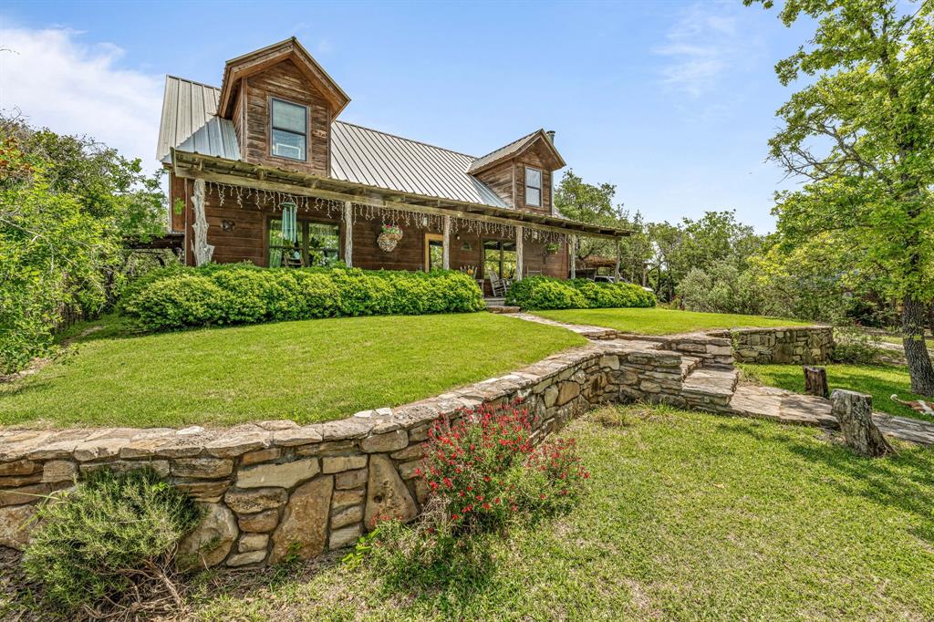 This one is really special! It is a beautiful custom built Fanning Construction home sitting on just over 27 acres of land! This property is located in the very desirable Huckabay school district! This home has been so well loved and cared for since the seller's built it! Sometimes life throws us a change up and now it is being offered up for someone else to come enjoy and love it as much as they do! The home features 3 bedrooms, 2 full and 1 half bath, it also has beautiful kitchen, wood burning stove, and the most peaceful study! You can't imagine how peaceful it is to sit on the porches and listen to the wind chimes! There is a custom built chicken coop, and an in ground concrete storm shelter! There are tons of deer, and all kinds of wildlife on the property! This place is located at the end of a private road, and the road only services two homes. The property is ag exempt, and so private but it has state of the art United Coop fiber internet! There is also a nice horse barn and shed on the property. It is also completely fenced! If life is a little too hectic for you and you are looking for a weekend place or primary residence that will afford you the utmost peace and quiet... well here it is!! Come take and look and experience just how special this place truly is! The pictures are fantastic but they don't tell the whole story about this one! You have to come experience it for yourself!!
