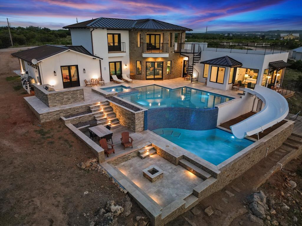 Discover a once-in-a-lifetime Lake Front home on Possum Kingdom Lake! Designed by a professional, this fully furnished masterpiece offers stunning lake views from every room and a rooftop deck. With 2 master suites, a gameroom, and 2 swimming pools—one for relaxation and one for fun—this home is a paradise. Unwind in the 12x9 ft Sauna or retreat to the Himalayan salt cave with 30K worth of imported salt located beneath the master bedroom. Located in Sportsmans World offering many amenities, this home is an unrivaled gem. Don't miss out on this exceptional opportunity!