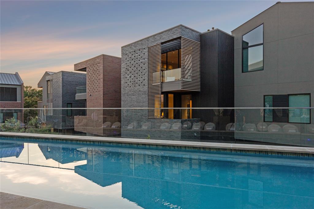 The Seven Residences at Bowie House offers a rare opportunity to own one of just seven sought-after residences located adjacent to Bowie House, part of the prestigious Auberge Resorts Collection in the heart of Fort Worth’s Cultural District. These residences blend refined design with timeless craftsmanship. The exterior features earth-tone brick and spruce accents, inspired by the traditional Japanese Shou Sugi Ban technique. A landscaped courtyard leads to an entryway with layered textures, venetian plaster walls and ceilings, and wide plank white oak wood flooring. A sculptural staircase sits under the expansive skylight, connecting all levels with natural light and elegance. With an elevator and a staircase connecting all levels, this home is perfectly suited for a lock-and-leave lifestyle, complemented by optional access to Bowie House hotel's five-star amenities and service. The third floor serves as the main living area, anchored by a fireplace, open layout, and oversized stacking floor-to-ceiling glass doors that lead to a terrace overlooking lush gardens. The kitchen features custom cabinetry, a premium appliance package, and luxurious countertops. A private two-car garage with basement storage and direct access to the home adds everyday ease. Optional access to Bowie House amenities includes pool, cabanas, spa, gym, dog park, valet, concierge, in-room dining, and priority reservations at Bricks & Horses. Steps from world-class museums, Dickies Arena, Will Rogers Coliseum, and top dining, The Seven is ideal for buyers seeking a lock-and-leave lifestyle in one of Fort Worth’s most vibrant and walkable neighborhoods.