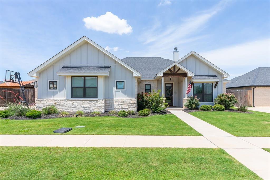 Welcome to this beautifully designed home in the highly sought-after Tributes community in South Abilene! Built in 2022, this 4 bedroom, 2.5 bath home offers a perfect blend of modern elegance, comfort, and functionality. From the moment you step inside, you’ll love the soaring ceilings, abundant natural light, and open-concept layout designed for both everyday living and entertaining.The spacious living area is centered around a stunning floor-to-ceiling fireplace with custom built-ins, creating a warm and inviting focal point. The chef’s kitchen features granite countertops, custom cabinetry, stainless steel appliances, designer lighting, a large island, and an oversized pantry perfect for storage and hosting.The private primary suite offers a relaxing retreat with a beautiful tray ceiling and spa-inspired ensuite bath complete with dual vanities, soaking tub, separate shower, and generous storage. Three additional bedrooms provide flexibility for guests, a home office, or playroom. A guest bath with dual sinks plus an additional half bath add extra convenience for family and visitors.Step outside to enjoy the covered patio and spacious backyard, ideal for entertaining or relaxing evenings at home. Located in The Tributes, residents enjoy access to a community pool and a wonderful neighborhood atmosphere. Zoned for highly desired Wylie ISD, this home offers style, comfort, and convenience all in one exceptional package.Move-in ready and loaded with upscale finishes, 3418 Ace is one you won’t want to miss!