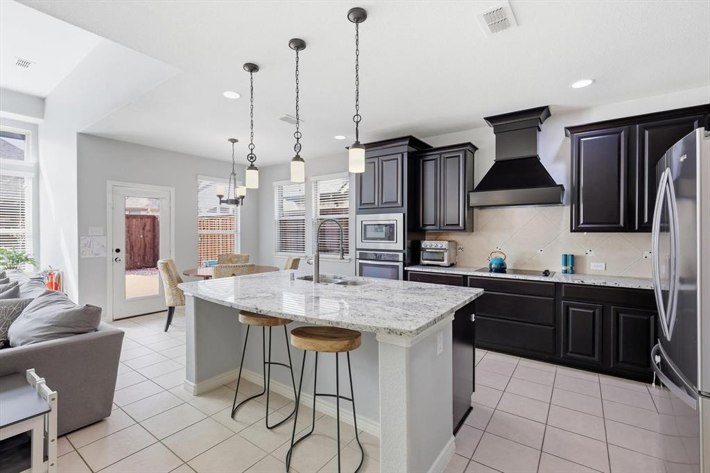 INCREDIBLE VALUE. PAID OFF SOLAR PANELS, allowing the next owner to enjoy significantly lower utility bills and long-term energy savings. What's more this beautiful two-story residence offers exceptional curb appeal with an inviting front porch, pristine landscaping, and an attractive water feature. You get a warm welcome from the moment you arrive. 
Step inside to bright  interiors with tall ceilings. Highlighted by light, neutral tones, well-maintained carpet, and a spacious, thoughtfully designed open floor plan. The home features two dining areas, both upper and lower living rooms, and a dedicated media room complete with projector and screen, making it ideal for entertaining and everyday comfort.
A private office provides the perfect work-from-home space but can easily function as a fifth bedroom to suit your needs. The stunning island kitchen is truly the heart of the home, showcasing attractive granite,  built-in stainless steel appliances, an abundance of cabinetry, great prep space, and an oversized pantry that offers exceptional storage.
The primary suite is a relaxing retreat featuring soaring ceilings, a massive walk-in closet, and a  luxurious soaking tub and separate shower. Upstairs living spaces provide flexibility for game nights, and 3 more bedrooms with a full bath.
Step outside to an extended stamped concrete patio, a part of which is covered, complete with a fire pit, creating the perfect setting for year-round entertaining or quiet evenings under the stars. The backyard offers plenty of room to relax and host guests in style.
Located in a prime central area just minutes from multiple shopping destinations, nearby parks, and endless dining options, this home combines comfort, convenience, and energy efficiency in one impressive package.