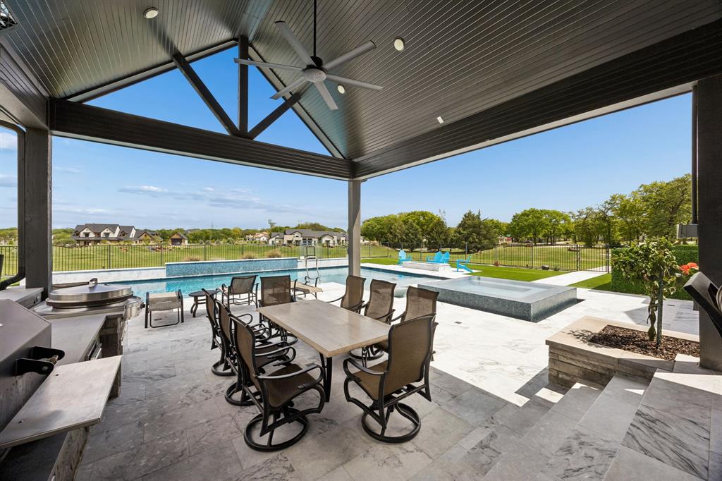 Located in prestigious Hat Creek Estates, this fully renovated Bartonville estate offers a rare blend of privacy, design, and resort-style living on 2.85 beautifully landscaped acres with rolling berms and mature trees. Extensive, high-quality updates throughout deliver a level of finish and functionality rarely found in Argyle ISD.

A welcoming front porch leads to dramatic double iron-and-glass entry doors and an interior where every detail has been intentionally curated. Highlights include a floating staircase, linear gas fireplace, custom designer lighting, and a light-filled open-concept layout ideal for both everyday living and entertaining. The chef’s kitchen anchors the home with premium appliances, including a built-in Miele coffee system and steam oven, along with an expansive walk-in working pantry that balances form and function.

Outdoor living is equally impressive. A custom Claffey heated diving pool and spa are framed by extended patios, lighted decks, built-in heaters, and a firepit, creating a true private retreat. Artificial turf surrounds the pool area and extends to a dedicated dog run. Entertaining is elevated with a built-in Yoder smoker and Evo flat-top grill, complemented by a whole-home audio system that flows seamlessly indoors and out. Lush professional landscaping is sustained by a full-property irrigation system supplied by a private well.

Additional features include a private Par-3 golf hole, 50-amp RV plug, secondary upstairs laundry, and extensive whole-home audio. While the property is part of the Hat Creek Estates HOA, it predates the association and is grandfathered from current architectural and construction restrictions, providing exceptional flexibility for future improvements such as an ADU or guest residence (buyer to verify). Located within Argyle ISD and benefiting from comparatively low tax rates, this move-in-ready estate presents a rare opportunity in one of Bartonville’s most sought-after communities.