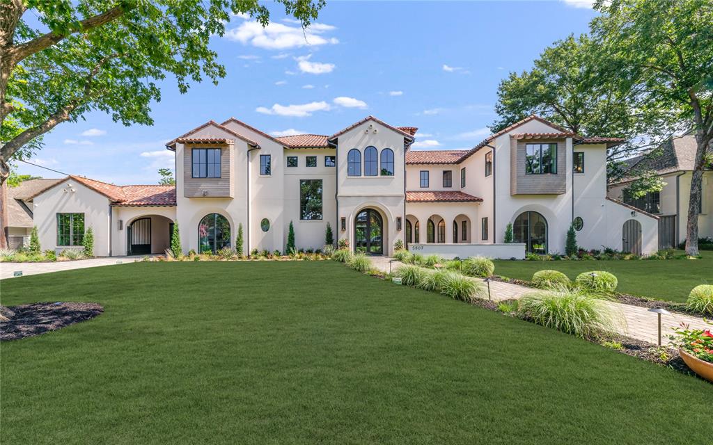 Masterfully crafted Santa Barbara-inspired modern estate, architected by Covert & Associates, designed by Julie Parrent Design Studio, and built by ICB Custom Homes, located in the coveted Devonshire neighborhood. Situated on a beautifully landscaped .51-acre lot, this exceptional 9,118 SF residence offers 5 spacious bedrooms, 6 full baths, 2 powder baths, 4 living areas, 2 dining areas, a private office, gym, elevator, whole-home generator capable, and a 3-car garage w lift capability. Designed for elevated living and effortless entertaining, the home showcases soaring ceilings, expansive windows, and impeccable craftsmanship throughout. A luminous foyer w barrel-vaulted plaster ceilings, artisan finishes, and designer lighting creates a striking first impression. The formal dining room is highlighted by a dramatic glass-enclosed wine display, while the stately front office features a floor-to-ceiling arched window and an Isokern fireplace. The open-concept living spaces flow seamlessly into a chef’s kitchen appointed w Sub-Zero and Wolf appliances, bespoke rift cut white oak cabinetry, and carefully curated fixtures sourced from around the world. Complementing the main kitchen is an exceptional fully equipped caterer’s pantry featuring a 36-inch Wolf range, extensive prep space, custom storage, and premium appliances, offering the ideal setting for entertaining, and seamless daily living. The private primary suite serves as a luxurious retreat, complete w a fireplace, serene backyard views, dual custom closets, a spa-inspired bath, and an infrared sauna. The first level also includes guest quarters and a dedicated media room. Outdoor living is equally impressive, featuring a resort-style pool and spa, covered patio, summer kitchen, maintenance-free turfed lawn, and beautifully landscaped grounds designed for year-round enjoyment. A rare opportunity to own a residence of exceptional scale, design, and craftsmanship in one of Dallas’ most prestigious neighborhoods.