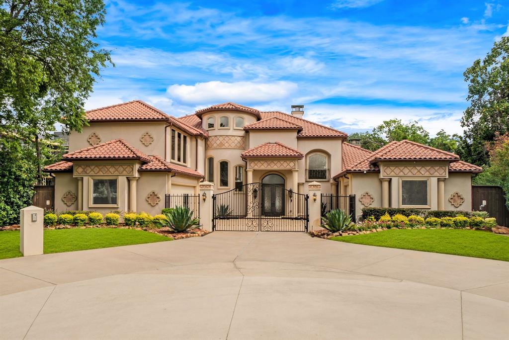 Experience luxury living in this exceptional custom estate featuring soaring 20-foot ceilings, elegant marble flooring, and a dramatic wall of windows overlooking the resort-style backyard. The gourmet chef's kitchen is equipped with Sub-Zero refrigeration, double Wolf ovens, a Wolf gas range, marble countertops, and abundant custom cabinetry. The spacious primary suite offers a fireplace, spa-inspired bath with a jetted tub, steam shower, dual vanities, and an oversized walk-in closet. A private executive office with a stunning backlit onyx wall adds both sophistication and functionality. Upstairs, enjoy a dedicated home theater and game room. The backyard is designed for year-round entertaining with a sparkling pool, tranquil koi pond, low-maintenance turf, and a fully equipped outdoor kitchen featuring built-in stainless-steel grills, granite countertops, extensive cabinetry, a full-size refrigerator, movable prep island, and convenient pool bath. Expansive sliding glass doors seamlessly connect the indoor and outdoor living spaces. Additional highlights include a gated entrance, circular driveway, and three-car garage. Ideally located just minutes from premier shopping, dining, and entertainment, this home offers the perfect blend of luxury, comfort, and convenience.