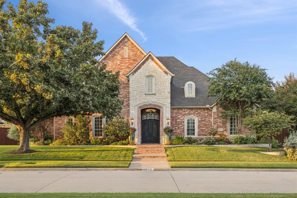 Set within the desirable Shoal Creek community, this elegant residence offers a refined lifestyle with access to a neighborhood jog trail and tranquil ponds. Ideally located just minutes from Grandscape and Legacy West, the home provides convenient access to premier shopping, dining, and entertainment. Outdoor spaces have been designed as a private retreat. A recently completed pool renovation features travertine pavers, Radiant Fusion Micro Pebble Plaster, and low maintenance turf. A separate covered outdoor living pavilion enhances the home’s entertaining appeal and includes a fireplace, pizza oven, two built in grills, refrigerator, and sink. At the heart of the home is an exceptional kitchen that serves as both a design focal point and a highly functional workspace. Generously scaled, the kitchen offers extensive cabinetry, granite countertops, and a lrg breakfast bar. The quality appliance suite includes Thermador stainless double ovens and gas range, built in stainless refrigerator and microwave, wine refrigerator, stainless dishwasher, water purifier, and disposal. Fabulous butlers pantry and oversized walk in pantry. Real hand scraped hardwood floors extend throughout the main living areas, kitchen, formal dining room, and dedicated office. The primary suite is located on the main level, along with a guest bedroom and full bath. The primary bath includes dual vanities, a separate garden tub, glass enclosed shower, and a custom walk in closet. The home offers five bedrooms, five and a half baths, and three living areas, including a formal living room and family room, both with gas fireplaces, and an upstairs living or game room. A large bonus room provides flexible use options. Storage is abundant with under stair storage, utility storage, and an extra large walk in storage closet off the bonus room. Additional features include updated bathrooms, a three car garage with epoxy flooring, security system, sprinkler system, and 8ft board on board fencing.
