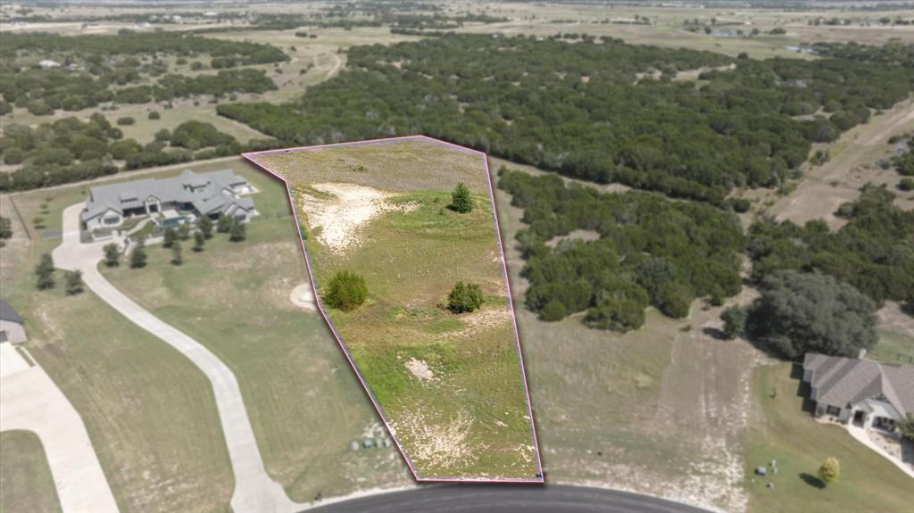 One of the largest lots currently for sale in the highly sought after gated community of Rolling Creek Ranch. A serene, cleared canvas of nearly 3 acres ideal for crafting your dream home in a peaceful, natural setting. This cleared and ready to build lot offers both privacy and potential, free from constraints of rear neighbors and with a layout that invites creative architectural vision. This setting offers a balance of quiet rural charm with easy access to Fort Worth and the broader DFW Metro area. Water tap has already been paid and connected!!! Your future dream home awaits you!