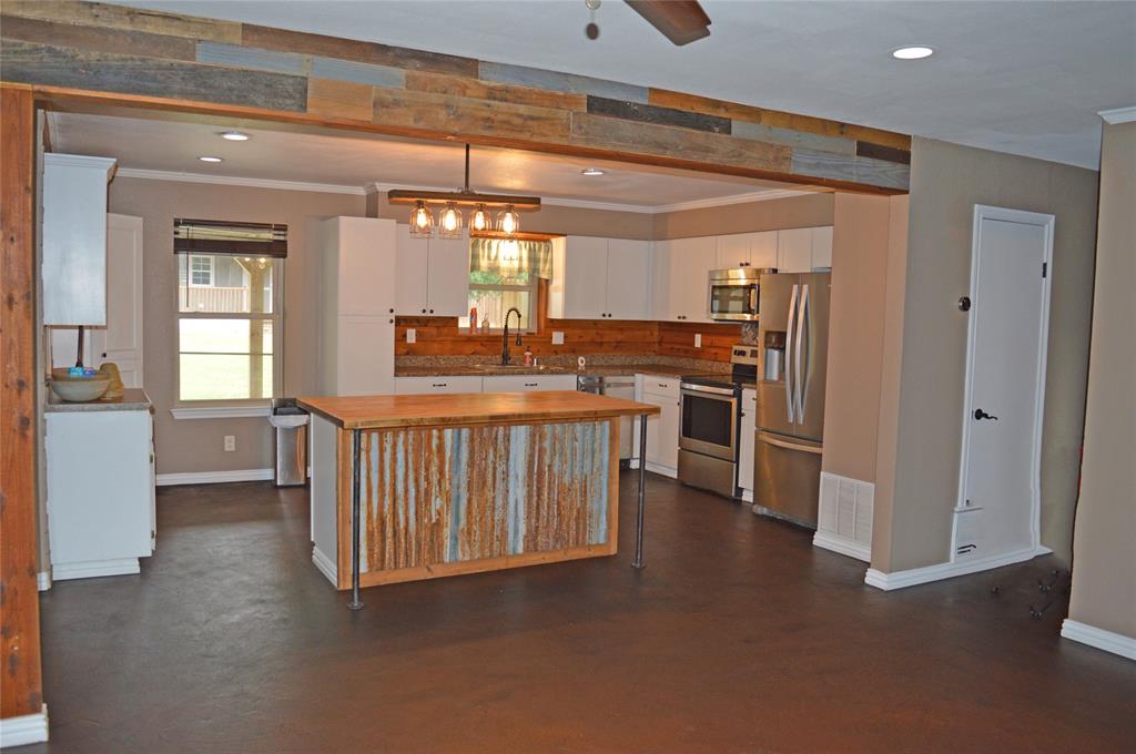 Very well-maintained home Southwestern style new landscaping, very energy efficient double pane windows that can be opened from the bottom or top window , Stainless steel appliances, Very Nice Whirlpool Stainless Steel refrigerator side by side doors with ice and water dispenser and bottom door freezer stays with the home. Great tall privacy fence with electronic gate that can be opened by remote or keypad.
New air-conditioning unit installed within the last two years, very nice 25x24 metal building with spray foam insulation recently built with multiple electric outlets, air lines installed with multiple air outlets in the shop and one on the outside front also a 20X24 covered carport attached to shop 10x24 lean-to on east side.
Very nice 12x24 outbuilding shed completely remodeled inside new floors, paneling full insulated with mini-split heating and air conditioning to keep you cool in the Summer and very warm in the Winter, two upper lofts, electric and lights also plumed for water to sink and toilet.
Stone fire pit next the shop.
All of this for comfort and very close Lake Grandbury boat ramps and the Brazos River.