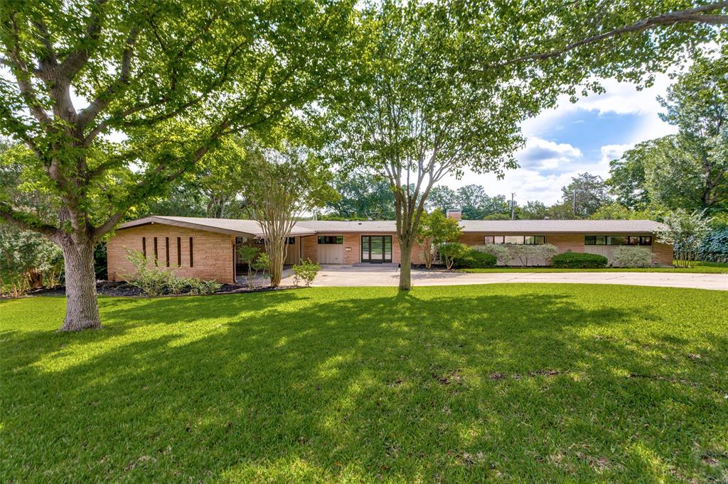Tucked away on a coveted corner lot in one of Fort Worth’s most sought-after neighborhoods, this rarely offered one-story mid-century modern blends timeless architecture with sophisticated updates and an unbeatable location. Surrounded by mature trees and lush landscaping, the home offers exceptional privacy and seamless indoor-outdoor living. Walls of windows fill the expansive living spaces with natural light, while clean lines and thoughtfully updated finishes create a warm yet contemporary feel throughout. Designed for both comfortable daily living and effortless entertaining, the home features four spacious bedrooms, three full and 2 half baths, and multiple inviting gathering spaces. Numerous closets, custom built in units and 2 outside storage areas provide ample storage. Chefs' kitchen with built-in pull-out table and extensive granite counters in the dining room make meal prep and serving a delight. Step outside to your own private retreat — a spectacular oversized pool, generous patio areas, and a beautifully secluded backyard setting complete with a putting green creates the perfect backdrop for relaxing summer days and memorable evenings with family and friends. Ideally located near the area’s premier park, walking and bike trails, Shops at Clearfork, TCU, and the prestigious Colonial Country Club, this exceptional property also lies within a highly desirable elementary school area. A rare opportunity to own an architecturally distinctive home in an extraordinary location.