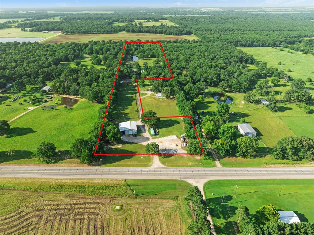 Just listed, a rare opportunity to own 12 acres with both residential charm and commercial potential, located at 10510 Hwy 82 East in Blossom, TX. This unique property features a beautiful stone home with a durable metal roof, tucked away from the highway for added privacy, yet offering excellent road frontage for visibility.

The home offers 2 spacious bedrooms, 1.5 baths, two living areas, an office space, and a dining room. A large stone fireplace anchors the main living area, creating a warm and inviting atmosphere. Enjoy quiet mornings or evening gatherings on the peaceful patio that overlooks a fenced back pasture with a serene pond.

Seller is offering up to $10,000 in concessions with an acceptable offer, providing a great opportunity to assist with closing costs, rate buy-downs, or other buyer expenses.

The property includes multiple outbuildings, RV parking, and a greenhouse, perfect for homesteading or hobby farming. One of the standout features is the expansive 50x60 commercial-grade shop, complete with a 20x60 overhang, loft, office space, and its own restroom, ideal for running a business, workshop, or additional storage.

With prime Hwy 82 frontage and plenty of room for signage, this property offers tremendous exposure for any business. Whether you're looking for a work setup, investment opportunity, or a peaceful rural escape with endless potential, this one of a kind property checks all the boxes.

don’t miss your chance to make it yours!