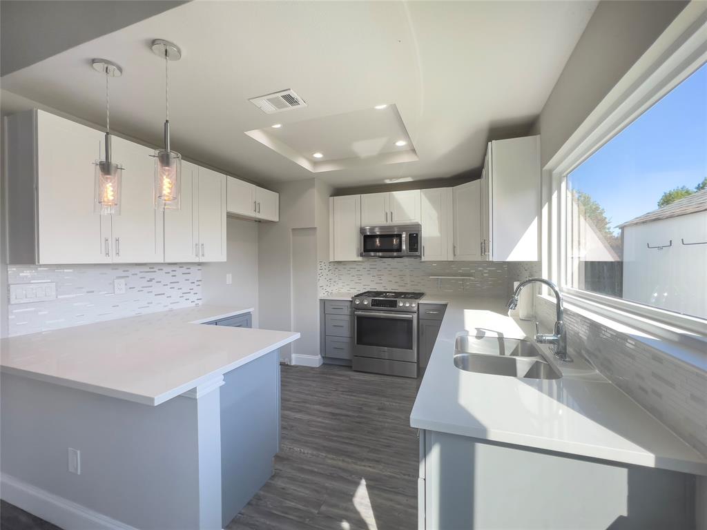 Charming, bright, extensively remodeled 3 bedroom, 2 bath home on interior lot in quiet, established North Garland neighborhood offering convenience and tranquility.  Spacious floor plan features beautiful kitchen open to family room with vaulted ceilings and fireplace, large primary bedroom with beautiful ensuite bath, a modern color palette and windows that let in lots of light! Amazing recent remodel includes stainless steel kitchen appliances, kitchen quartz countertops with glass tile backsplash, primary bathroom vanity with quartz countertops, seamless glass shower enclosure and tile surround, secondary bathroom vanity with tub and tile surround, HVAC system, vinyl plank and tile flooring, triple pane windows, interior and exterior paint, water heater, lighting, fixtures, and more! Backyard storage shed. Located close to the Spring Creek Forest Preserve, Firewheel Town Center, and easy access to President George Bush tollway and lots of restaurants, grocery stores and more!