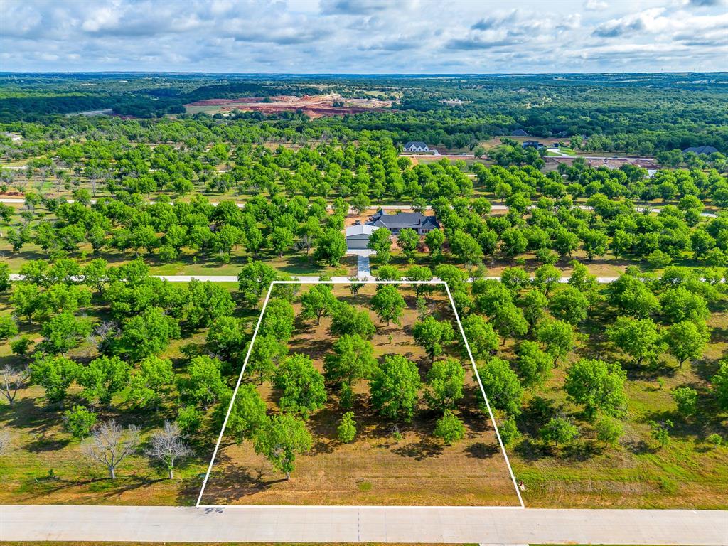 Howdy! Welcome to The Landings East at Pecan Plantation, the LARGEST Airpark in the State of Texas and the 3rd LARGEST in the US! Direct access to the Taxiway. LOT 3927, 1624 Earhart Dr, 1.502 ACRES. LOT dim 190 x 343 x 190 x 342.  Seller has Survey, Seller has paid $2500 OIC Tap fee.  Full of mature pecan trees. Site is complete with paved roads, electric service, MUD water, MUD sewer. Orchard irrigation & high speed internet available. Min SQFT to build is 2,000. No time frame to build. Hangars may be constructed with residence but not built prior to construction of home. FAA Identifier: 66TE PPOA Discover the exceptional lifestyle of Pecan Plantation, a private, gated community nestled along 17 miles of the historic Brazos River within a 4,200 acre pecan orchard. Enjoy resort style amenities including two championship golf courses with full practice facilities, a full-service clubhouse with multiple dining options, marina with access to Lake Granbury, tennis & pickleball courts, pools, dog park, riverside parks, Airparks, camping, & 24 7 security with Fire & EMS services. The Village, features a bank, grocery store, restaurant, Pecan Medical Clinic, PT Services, pharmacy, golf cart shop, Vet Clinic, car wash, & Ace Hardware. Just minutes from the Historic Granbury Square officially the “Celebration Capital of Texas” under an hour from Fort Worth. Experience the perfect blend of tranquility, recreation, and convenience. Come see why you’ll want to build your dream home here! PPOA Mandatory Membership as of 9-1-25: PPOA Transfer Fee 1,091.00 + 73.65 (tax) = 1,304.49. Initiation Fee 4,381 EQUALS: 5,545.65 The monthly fee is 204.75 and includes trash service or 182.75 without trash service. Search YouTube 'Airplane Ride Around Pecan Plantation Rebecca Van Buren' to learn about our amazing community.