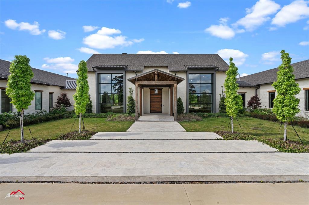 Custom built by Ryan Smith, this home couldn't be replicated!  The steel soaring 40 ft windows to the antique reclaimed wood thoughout the home, along with countless amenities, make this one of a kind!  The home welcomes you to soaring ceilings with open floor plan to the living, dining and kitchen, the ultimate entertaining home!  Walls and windows of glass make the light shine though with focus on the overwhelming green views of the pool, patio and backyard, with infinity pool, spa and outdoor kitchen and entertaining space.  The outbuilding can house the finest collections of cars or workshop and storage for anything imagineable.  Outdoor living area with fireplace and full bath inside.  The owners suite is lavish and luxurious with custom antique wood ceiling and a bath to make you the envy of anything you've ever seen!  The walk in closets and luxury just surround you with separate vanites, custom exotic tiled shower and Vessel Tub.  The Game room for entertaining, home theatre features a full wet bar area as well.  The amenties are too many to list, to understand what has gone into this home.  There are other photos, virtual walk through matterport available.  Please contact your favorite Realtor if your looking for a one of a kind exceptional property on huge lot in the every popular town of Benton.  With no rear neighbors and the best of Bossier within minutes.
