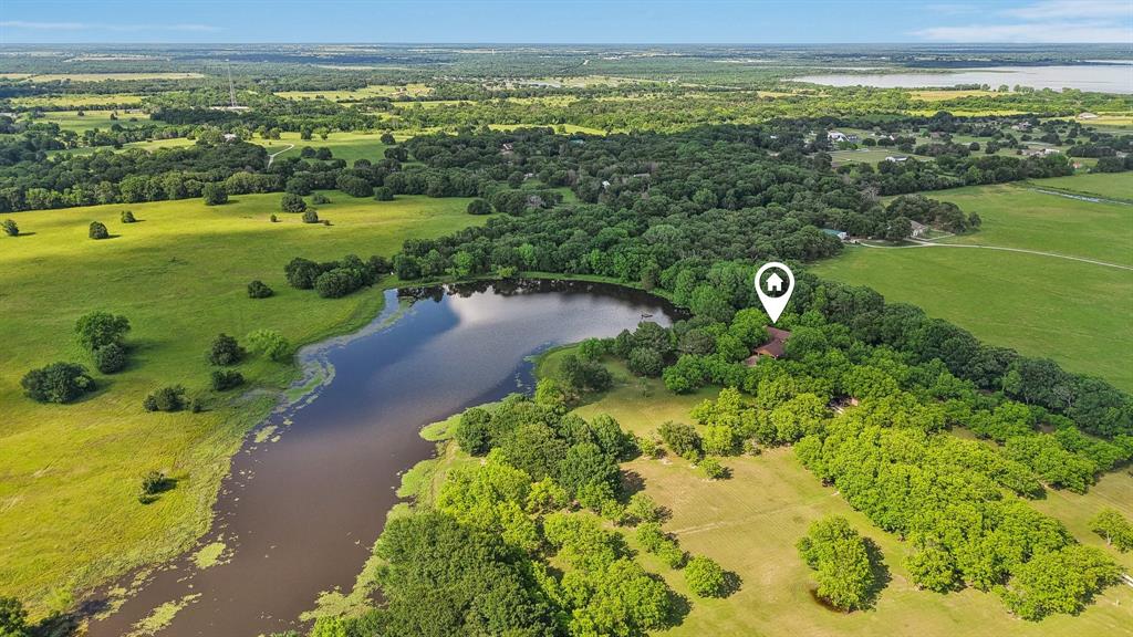 NEWLY GATED. NEWLY FENCED. NOW OFFERING 50± ACRES. A rare opportunity to own one of the most private and picturesque ranch estates in East Texas.  For the first time ever, Pecan Ridge Ranch is being offered for sale. Located at the end of Fogleman Road near Cedar Creek Lake, this remarkable 50±-acre estate has recently been enhanced with a new gated entrance and newly fenced frontage, creating a welcoming sense of arrival while clearly defining the property's entrance and boundaries.  As you pass through the gate, a winding drive leads to a custom-built mountain-style residence overlooking a private interior lake, creating a setting rarely found within an hour of Dallas.  The land is the true star of the property. Rolling terrain, mature pecan trees, a productive pecan orchard, scenic lake views, and neighboring ranchland combine to create an environment that feels generations removed from city life. Whether envisioned as a family compound, weekend retreat, horse property, cattle operation, recreational ranch, or future legacy estate, the possibilities are endless.  The custom 3-bedroom, 3-bath home was thoughtfully positioned to capture views of the lake and surrounding countryside. Inside, a dramatic stone fireplace serves as the heart of the home, complemented by warm architectural details and timeless mountain-lodge character. A spacious garage, mature landscaping, and room for future expansion provide flexibility for the next owner's vision.  Bordering a neighboring cattle ranch and surrounded by the quiet beauty of East Texas, this property offers a level of privacy and tranquility that is increasingly difficult to find.  Located approximately 46 minutes from Dallas, Pecan Ridge Ranch delivers the rare combination of accessibility, seclusion, and scale.

Legacy properties are not created overnight. They are assembled, improved, cared for, and passed from one generation to the next.
Pecan Ridge Ranch is ready for its next chapter.