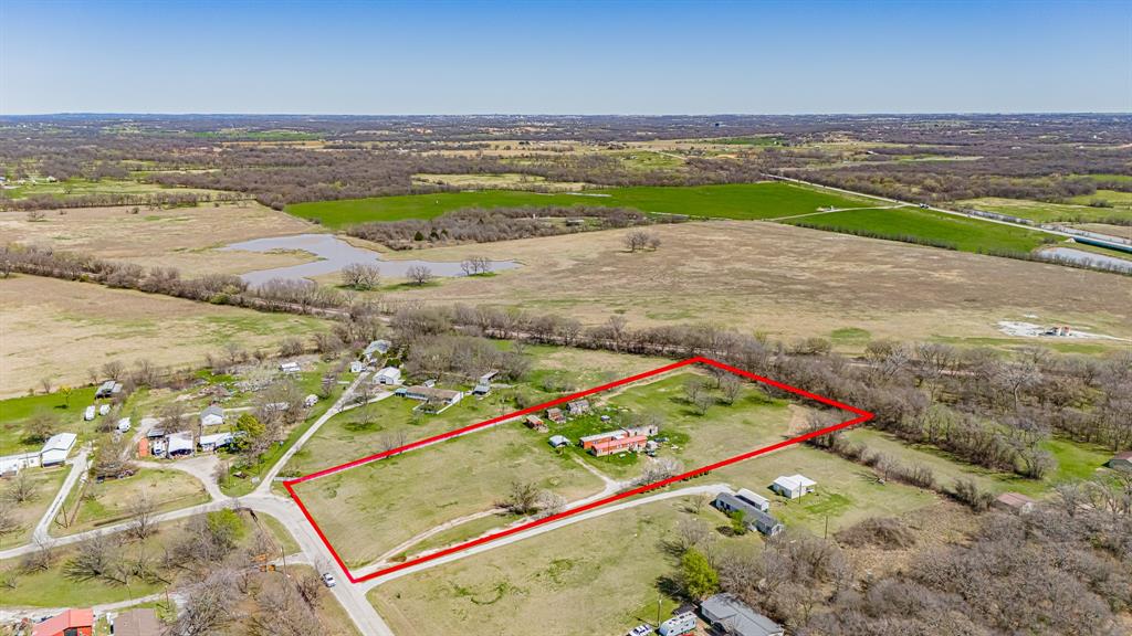 Welcome to Paradise, Texas where the name truly reflects the setting. This scenic 5-acre, tree-covered property offers a unique opportunity for both investors and future homeowners. The land is lush and green year-round and features two well-maintained mobile homes, both currently producing income.

The first home offers 3 bedrooms and 1 bathroom, while the second features 2 bedrooms and 1 bathroom. Both homes have new roofs and are separately metered for electricity, which is paid by the tenants. City water services the property, with usage handled between the tenants, and there are two separate septic systems in place.

With no zoning restrictions, this property offers flexibility—continue operating as a rental investment, build a new home, or explore other permitted uses. A county restriction allows one home per 2.5 acres, providing additional development potential.

The property currently generates $1,660 in gross monthly rental income, with both tenants on month-to-month leases, offering flexibility for a new owner.

Owner financing is available with a substantial down payment at 5% interest for 20 years, making this an attractive opportunity to own acreage in a desirable rural setting.