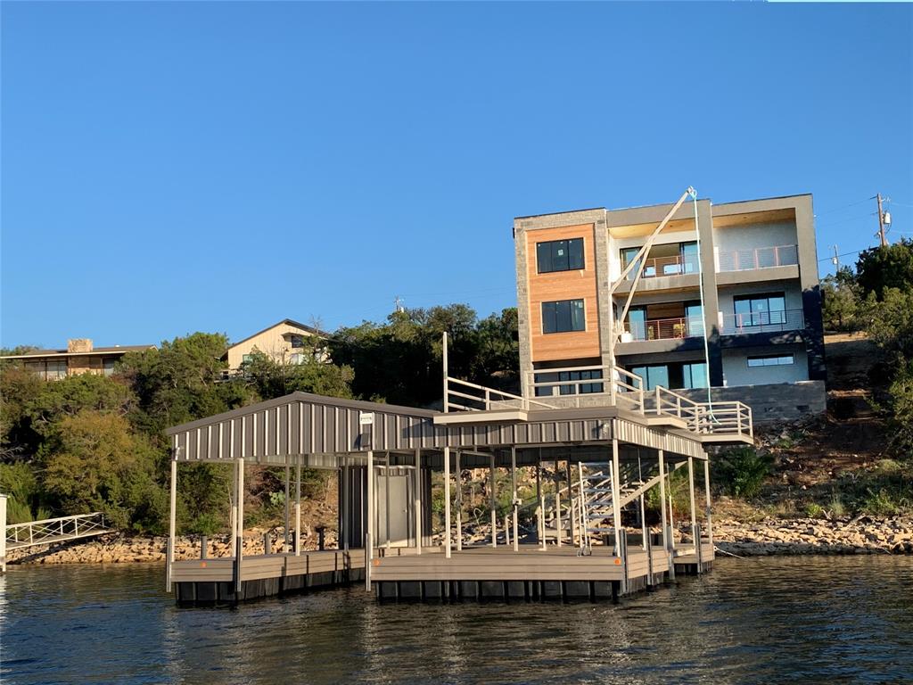 UNDER CONSTRUCTION an amazing NEW LAKE HOUSE in an excellent location… so close you could swim to famous landmark Hells Gate! Modern 3 story, 5 BR 6 BA designed by Blake Architects. Stone, stucco and wood exterior, flat roof, modern black doors & windows. Bosting 6,667 Sq Ft under roof, 4658 Sq Ft HVAC, two car garage, concrete drive. Panoramic lake views from all levels.  Mega porches and patios for comfortable outdoor living.  A fantastic SWIMMING POOL is also under construction with Hot Tub, Sunken Firepit, Outdoor Kitchen. Deep water NEW DOUBLE DECKER BOAT DOCK soon to be delivered with 29 Ft Boat Slip & Lift, Two PWC Slips & Lifts. In popular Gaines Bend Development on the south end of the clearest blue waters of Possum Kingdom Lake. Many special features, top-grade appliances. Ask for building plans and details.  Completion expected within a few months. Check back for updates IF still available... opportunities like this to have ALL NEW and not go to all the trouble are R A R E.