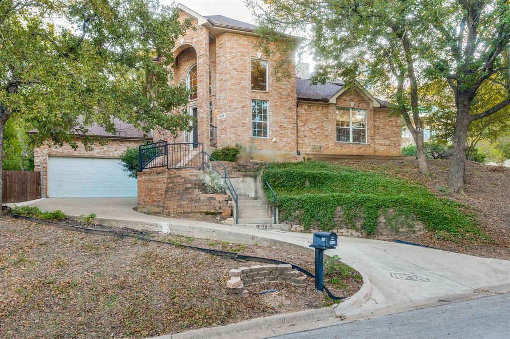 Welcome to the rolling hills of beautiful Arlington.  This beauty is situated overlooking the gorgeous view of Enchanted Oaks Subdivision.  This home features an oversized living dining combination with a fireplace in between OR a HUGE family area that is adjacent to the wonderful main kitchen, with loads of cabinets, a GREAT island for prep and a serving bar adjacent to the dining area; but don't miss the mini kitchen combination in the laundry with its own gas range and stove and separate sink AS WELL AS a utility sink.  This is every mom's laundry dream! The primary bedroom is located on the first floor with a HUGE primary bath with dual sinks, extended vanity area and a bidet, with separate shower and jetted tub.  Be sure to see  the linen closet and the ENORMOUS walk-in closet.  The upstairs has either 3 bedrooms or 2 bedrooms with a study.  One bedroom, with a walk-in closet, has French Doors, could easily be used as a study.  A Jack and Jill bath is ideal for getting the kiddos ready for school with separate sinks and a  shower!