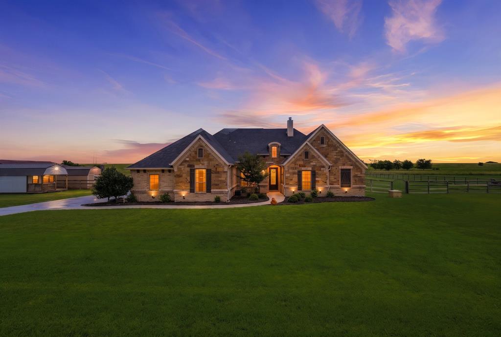 Welcome to refined Texas acreage living in sought-after Heritage Creek North! Nestled on 2 beautiful acres, this custom-built 4 bedroom, 3 bath home offers the perfect blend of luxury finishes, well planned upgrades, and timeless country charm. From the moment you step through the impressive 8’ front door, you’ll notice the soaring vaulted ceilings, hand-scraped hardwood flooring, and custom touches throughout the home.

The spacious living area is anchored by stunning beams and flows seamlessly into the gourmet kitchen featuring a Wolf gas cooktop, double ovens, built-in microwave, oversized copper farmhouse sink, custom cabinetry, and expansive prep space perfect for entertaining. The dedicated office provides an ideal work-from-home setup while the open concept floor plan allows for both functionality and comfort.

The oversized primary suite was thoughtfully expanded to create an incredible spa-inspired bath complete with an oversized clawfoot tub, dual-entry walk-in shower with pebble stone flooring, and an enormous custom closet. One secondary bedroom features a built-in loft bed adding both character and functionality.  The 4th bedroom is separated allowing for it to be a room for your needs - game room or maybe generational living!

Designed for both comfort and efficiency, the home also includes spray foam insulation, a commercial-grade electric water heater, and a 3-car garage. Step outside to enjoy the built-in Memphis Grill pellet smoker, covered patio, and wide-open Texas skies! Additional features include a built-in 50 AMP RV plug, 8’ interior doors throughout, and luxury finishes rarely found at this price point.

Even more impressive? This property offers an assumable VA loan at an incredible 2.39% interest rate for qualified buyers — a rare opportunity in today’s market. Experience elevated country living just minutes from town conveniences, shopping, dining, and schools.