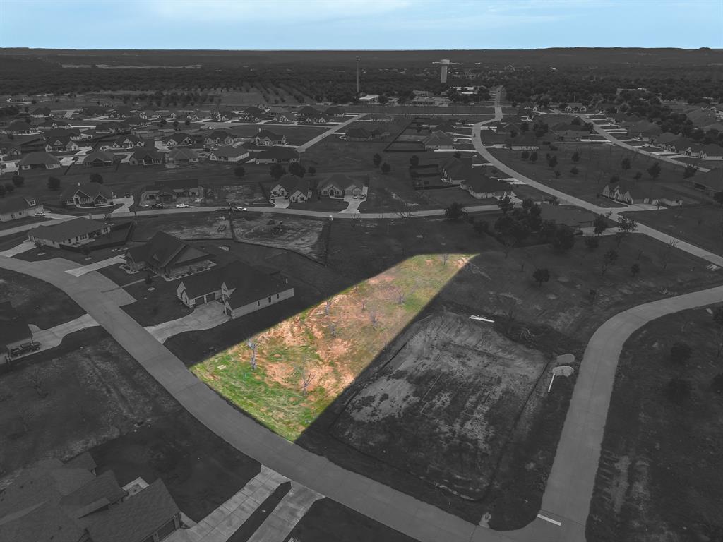 Howdy! Build your dream home on this beautiful pie-shaped lot nestled in one of the newest sections of Pecan Plantation! Spanning just over a half acre, this lot offers the perfect blend of privacy, open space, and stunning views. Ideally located in the heart of the community, you’re just moments away from The Village, featuring a grocery store, restaurant, pharmacy, golf cart shop, car wash, the newly opened Ace Hardware, and much more. Pecan Plantation boasts a wide range of top tier amenities including two golf courses with full practice facilities, two private airstrips, a clubhouse, dog park, disc golf, swimming pools, as well as tennis and pickle ball courts. Just minutes from the charming Historic Granbury Square, known as the Celebration Capital of Texas. And under an hour from Fort Worth, this is the ideal location to enjoy both tranquility & convenience. LOT 3630 in Orchard 15B, 2413 Candlestick Dr .558 acres. PIE SHAPE LOT approx 117 x 170 x 93 x 321.Site is complete with paved roads, electric service, MUD water, MUD sewer. Orchard Irrigation and High speed internet available. Min SQFT to build is 1,800. No time frame to build. Come see this area of Pecan and why you want to build here! PPOA Mandatory Membership as of 9-1-25: PPOA Transfer Fee 1,091.00 + 73.65 (tax) = 1,304.49. Initiation Fee 4,381 EQUALS: 5,545.65 The monthly fee is 204.75 and includes trash service or 182.75 without trash service. Search YouTube 'Airplane Ride Around Pecan Plantation Rebecca Van Buren' to learn about our amazing community. Sign on property.