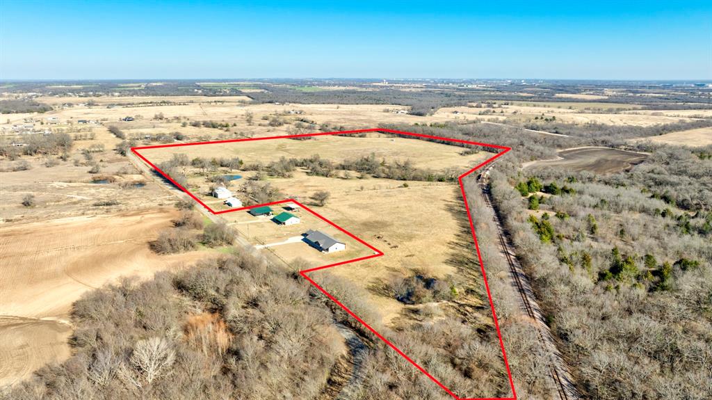 This home features a large 2,008 sq ft shop, perfect for commercial or agricultural use. The 49 acre is AG-exempt, fully fenced and cross-fenced, and located near Sherman’s upcoming growth area. Just 5 minutes from a private airstrip—fly in and check on your spread with ease. Enjoy mature trees, expansive views for days, and two ponds ideal for livestock. With road frontage on both sides of the property, this land offers excellent access and flexibility. Whether you’re looking for a smart investment or a peaceful retreat to unwind and relax, this property delivers.