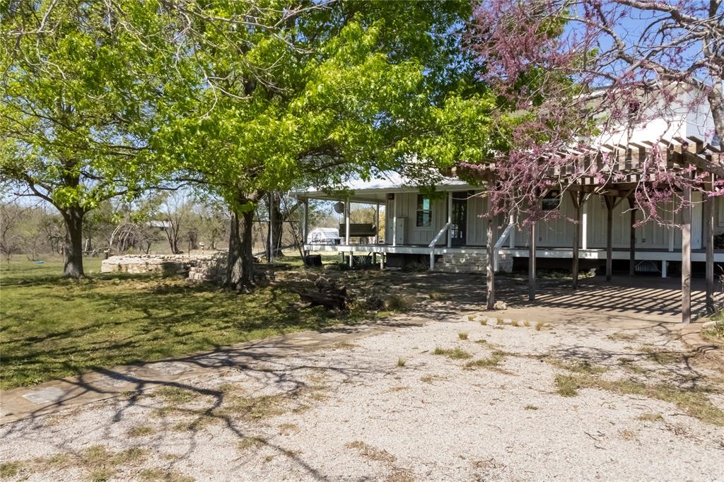 Completely move-in ready with repairs and updates already completed, this remarkable 1870 stone home is situated on 21.5 scenic acres just minutes from Stephenville along Hwy 67. Rich in Texas history and timeless character, the property offers the ideal blend of historic craftsmanship, functional improvements, and usable acreage for today’s country lifestyle.

The home features 3 bedrooms and 3 full bathrooms, along with a versatile basement area that provides additional storage or flexible living space. Carefully maintained over the years, the residence showcases original hardwood floors, solid stone construction, and spacious covered porches that capture the authentic charm and warmth of a classic Texas homestead.

A separate guest apartment adds outstanding flexibility to the property, complete with its own bedroom, bathroom, kitchen, and living area—perfect for guests, extended family, ranch help, or supplemental rental income opportunities.

The 21.5-acre tract is both attractive and highly functional, featuring improved grasses, perimeter fencing, and a gated entrance already in place. Additional improvements include a horse barn, multiple equipment sheds and carports, and a traditional windmill accompanied by a stone water trough that enhances the property’s unique ranch character.

For buyers seeking additional flexibility, the property is also available in an approximately 10-acre configuration, with additional adjoining tracts available in roughly 10-acre increments to accommodate a variety of needs and visions. Whether you are looking for a manageable country retreat or a larger ranch setup, this property presents a rare opportunity to own a historic home with exceptional versatility in one of the most desirable areas near Stephenville.