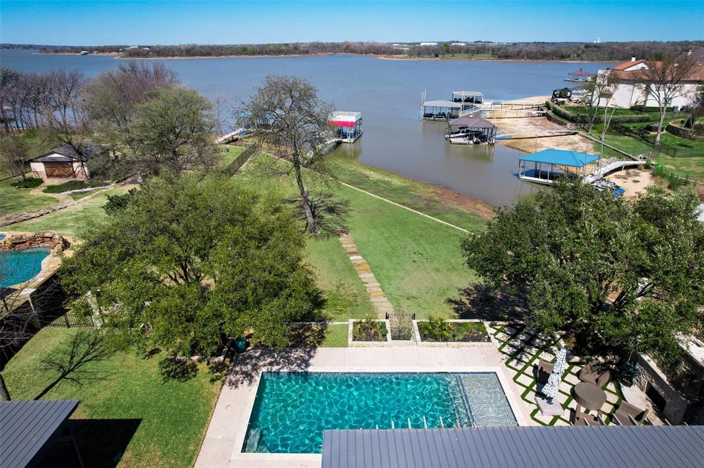 Stunning waterfront home located on the open water in the 24 hr. gated & guarded Resort on Eagle Mtn. Lake. This home was completely gutted and remodeled by an interior designer. The finishes & attention to detail are unmatched. Not to mention, the entire home comes FULLY FURNISHED! This property features an open floor plan which was meticulously designed to entertain & enjoy waterfront views from every angle in the main living areas. Gorgeous chef inspired kitchen with ice maker and built in fridge, as well as an enormous island offering tons of additional seating & storage. Outside is truly your own private oasis. Enjoy the multiple seating areas, beautiful saltwater pool overlooking the lake, hot tub, built in outdoor grill that features a large stone fireplace, plenty of yard space by the water, and two story boat dock. Community includes 18-hole golf course, clubhouse restaurant & bar, 2 pools, fitness center, tennis & bball court.
